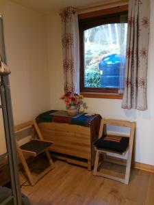 a room with a window and a table and a chair at Pammy's Family Annexe EXCLUSIVE USE in Garve
