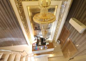 a large chandelier in a store with a table in front of it at Beirut Hotel 1 in Amman