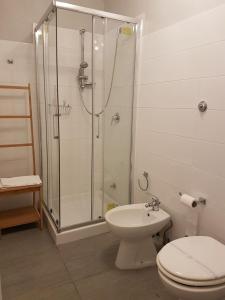 a bathroom with a shower and a toilet and a sink at B&B Dell'Opera in Naples