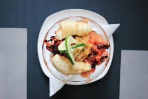 a plate of food with food on a table at Musanto Hotel in Gisenyi