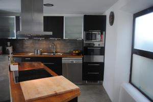a kitchen with a wooden counter top in a kitchen at Apartamento Loft en Tarifa in Tarifa