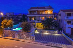 a villa with a swimming pool at night at Villa Mateja in Novalja