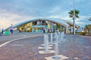 a large building with people walking in front of it at Savoy in St Paul's Bay