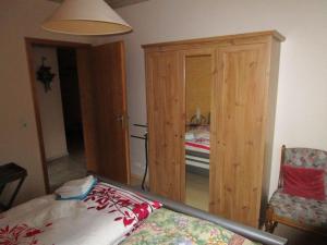 a room with a bed and a cabinet and a bedroom at Haus-Kummeleck-Wohnung-3 in Bad Lauterberg