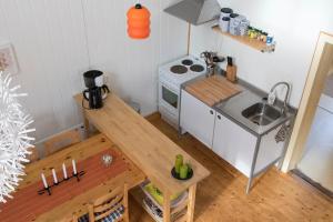 a small kitchen with a table and a stove at Stuga Lugnvik in Lugnvik