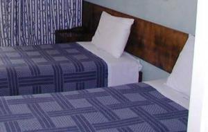 Postel nebo postele na pokoji v ubytování Oasis Hotel