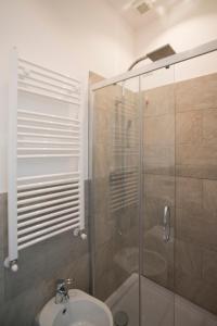uma casa de banho com um chuveiro e um lavatório. em La Maison Extravagante em Saronno