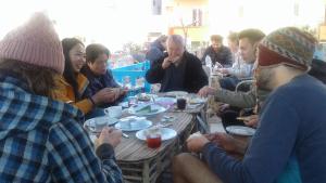 a group of people sitting around a table eating at Sea Waves Hostel in Hurghada