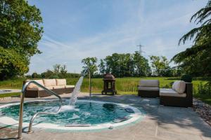 a hot tub with a fountain in a yard at Thornton Hall Hotel & Spa in Heswall