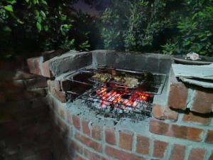 a brick oven with food cooking in it at Sea Waves Hostel in Hurghada