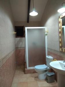 a bathroom with a toilet and a sink at Finca El Carrascal in Murcia
