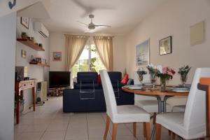 a living room with a table and a couch at Aurora Townhouse - Complimentary Paphos Airport Transport in Paphos City