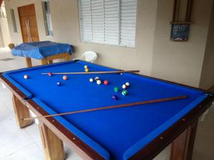 a pool table with billiard balls on it at Casa de Campo Serra Negra in Serra Negra