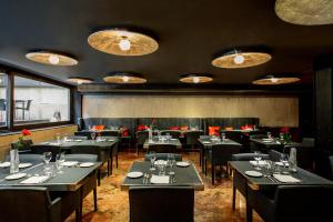 a restaurant with tables and chairs in a room at Hotel Granados 83, a member of Preferred Hotels & Resorts in Barcelona