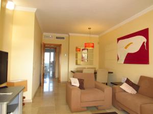 a living room with two chairs and a couch at Arenal Golf in Benalmádena