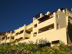 a white building with a roof on top of it at Arenal Golf in Benalmádena