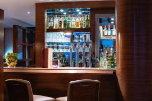 a bar with a lot of bottles of alcohol at The Club Hotel & Spa Jersey in Saint Helier Jersey