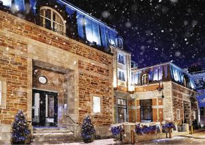 a brick building with christmas trees in front of it at Auberge Saint-Antoine in Quebec City
