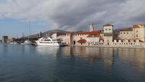 a group of boats docked in a river with buildings at Apartment Tina in Trogir