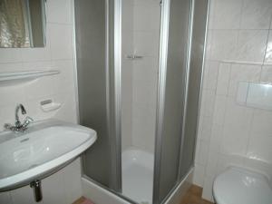 a bathroom with a shower and a sink and a toilet at Apartments Jäger in Trins