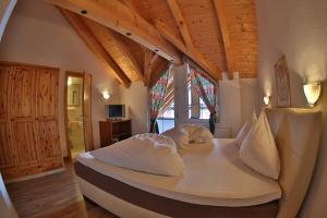 a bedroom with a large bed with white sheets and pillows at Dependance Central in Ischgl
