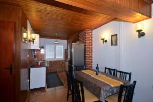 a kitchen and dining room with a table and a refrigerator at Apartment Mimica-Croatia , Omis , Center in Omiš