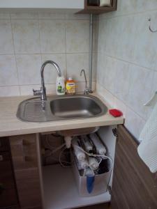 a kitchen counter with a sink in a kitchen at Pearl of Imanta in Rīga