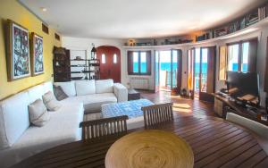 a living room with a white couch and a television at Tot Gaviota in Sitges