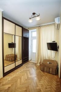 a living room with a large mirror and a tv at Halytska in Lviv