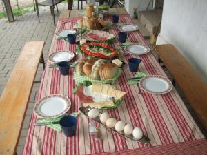 a long table with plates of food on it at Agroturystyka SZYSZKA in Polnica