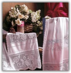 two towels on a table with a basket of flowers at Akti Damnoni in Damnoni