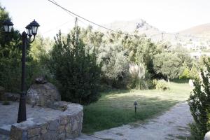 a street light sitting next to a stone wall at Akti Damnoni in Damnoni