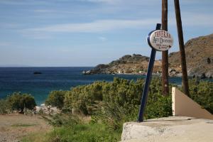 a sign on the side of a beach with the ocean at Akti Damnoni in Damnoni
