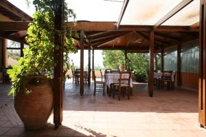 a patio with a table and chairs under a pavilion at Akti Damnoni in Damnoni +8 photos