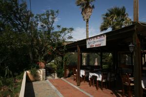 a restaurant with a table and chairs and a sign at Akti Damnoni in Damnoni