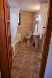 a bathroom with a toilet and a tub and a sink at Castle Cottage Bed & Breakfast in Belogradchik +38 photos
