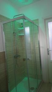 a shower with a glass enclosure in a bathroom at Bet Home in Palermo