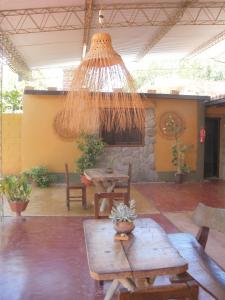 a patio with a table and a chandelier at Hostal Rustyk in Cafayate