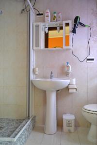 a bathroom with a sink and a toilet at Casa Vacanze Laura in Isola delle Femmine