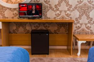 a television sitting on top of a table in a room at Pera City Hotel in Ankara