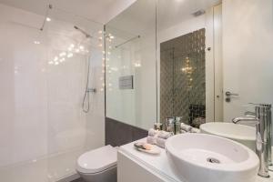 a white bathroom with a sink and a toilet at Oporto Platinum Loft in Porto +69 photos