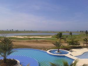 a resort with a pool and a golf course at Karibana Espectacular in Cartagena de Indias