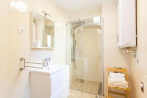 a white bathroom with a sink and a shower at Deluxe Villa Nina in Novi Vinodolski +29 photos