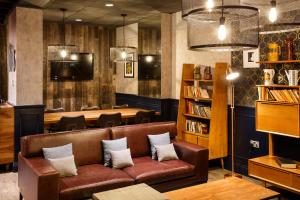 a leather couch in a restaurant with a table at ibis Manchester Centre 96 Portland Street in Manchester