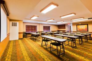 a classroom with rows of tables and chairs at AmericInn by Wyndham Monmouth in Monmouth +45 photos