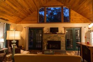 a living room with a couch and a fireplace at Heaven's Hideaway- perfect getaway near the river! in Luray