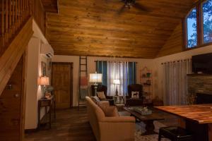 a living room with a couch and a table at Heaven's Hideaway- perfect getaway near the river! in Luray +19 photos