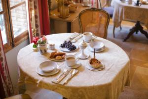 a table with plates of food on top of it at Les Rosées in Mougins