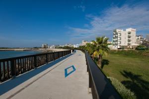 a walkway next to the water with buildings in the background at Jia Xiang Lin Guan Hai Homestay 2 in Magong