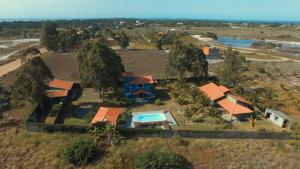 an aerial view of a house with a swimming pool at Mangaba Village in Barra Grande